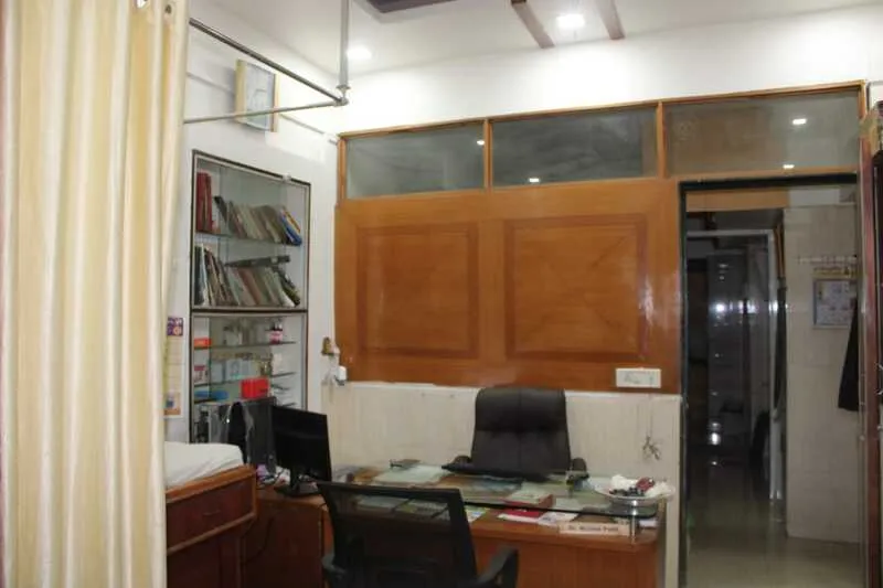 The consulting room, with the doctor's desk and bookshelves